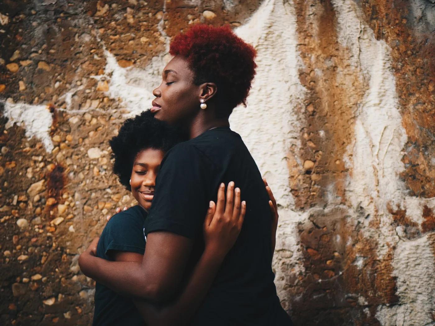 mother hugging her daughter