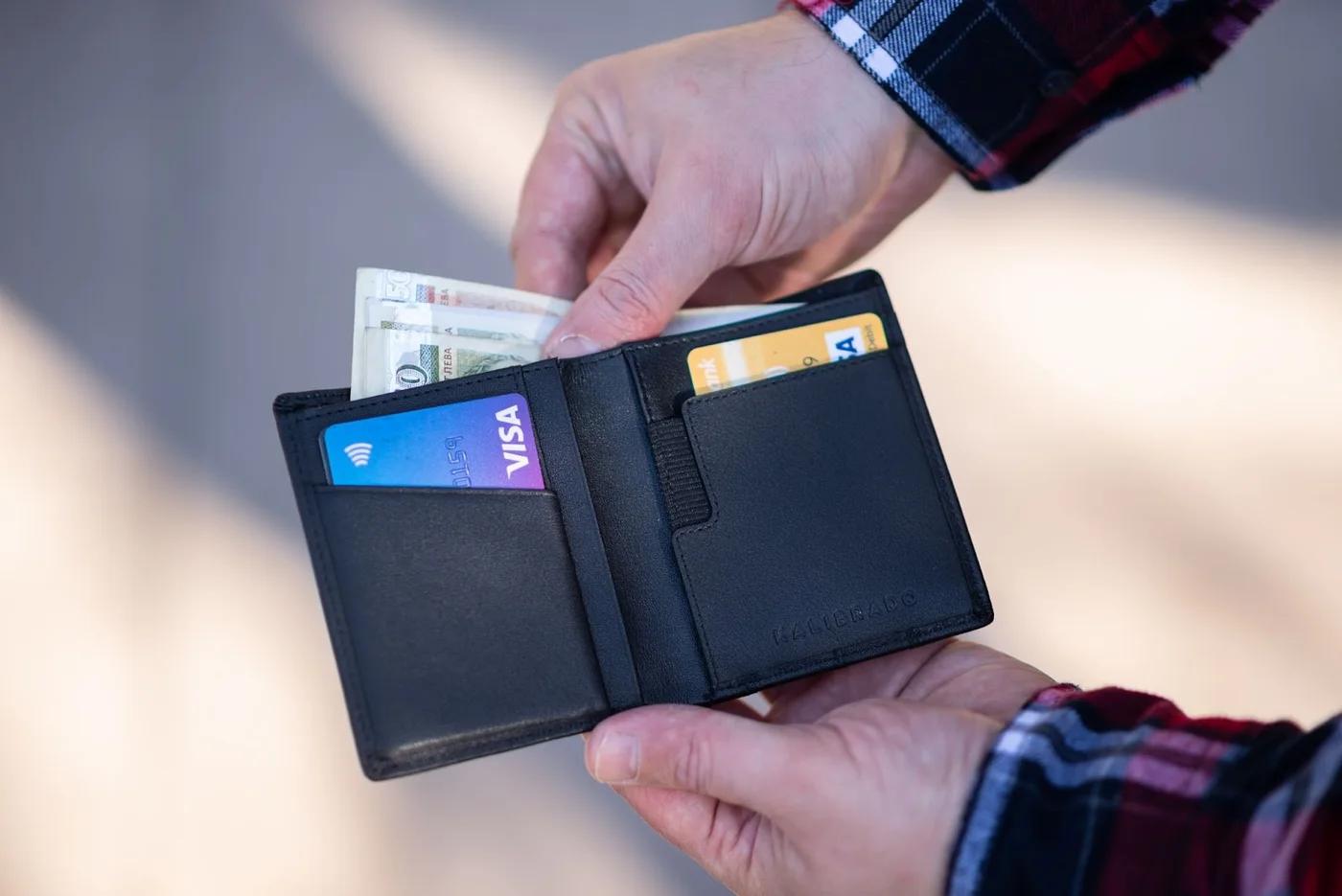 person getting credit card to pay